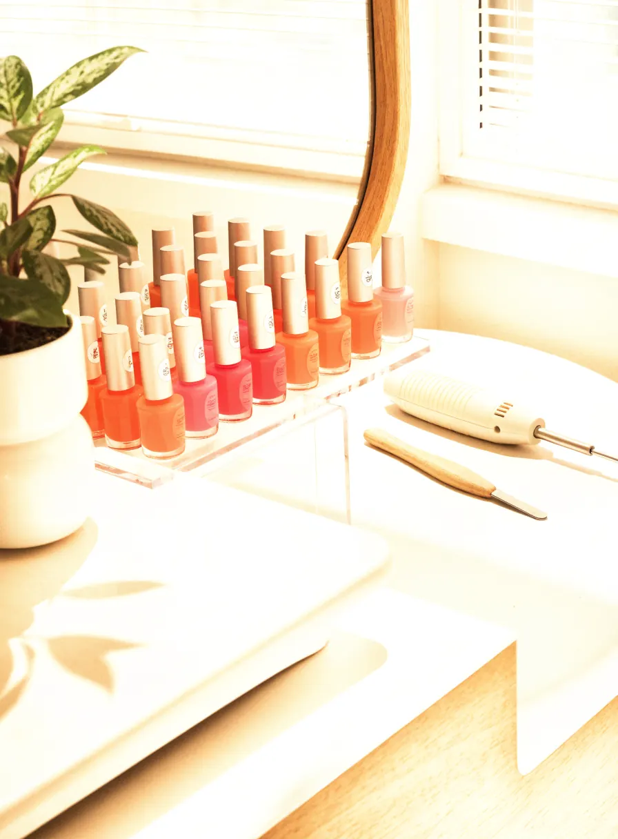 Bright nail salon manicure station with colourful polish bottles