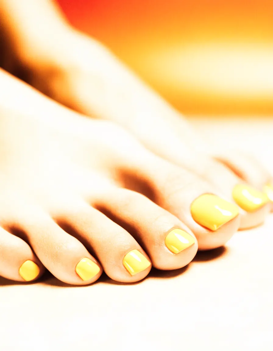 Freshly pedicured toes with glossy butter-yellow polish
