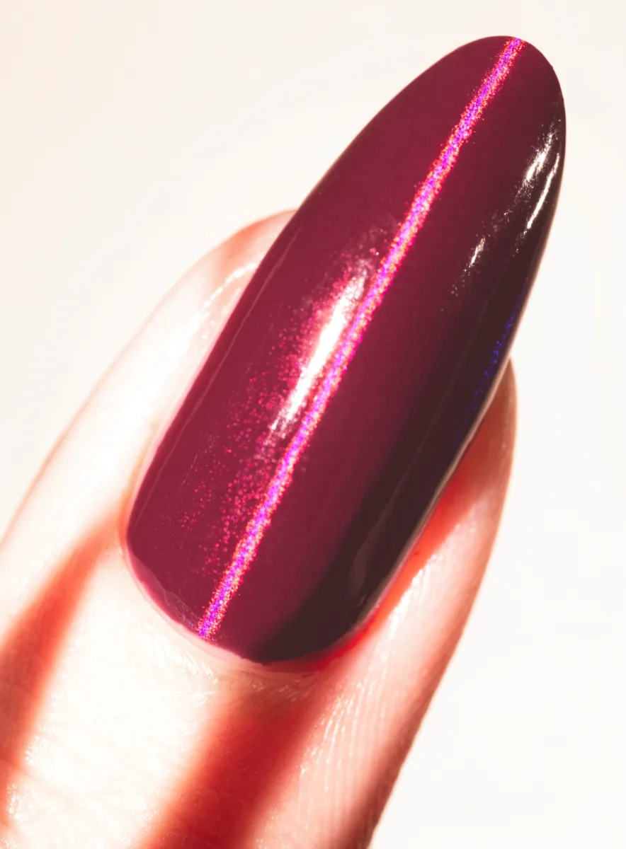 Macro close-up of a burgundy cat-eye nail