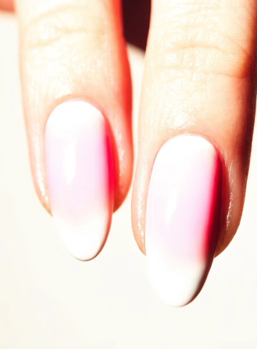 Close-up of fingertips with an ombre french fade